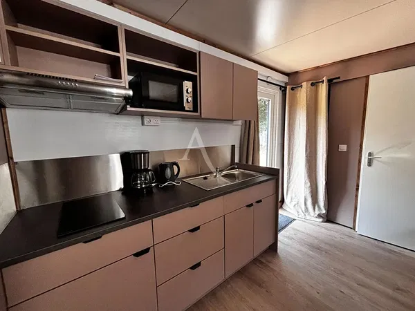 Kitchen; kitchen appliances, wood floor, natural light, modern style, renovated