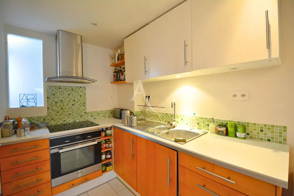 Kitchen; kitchen appliances, wood floor, natural light, modern style, renovated