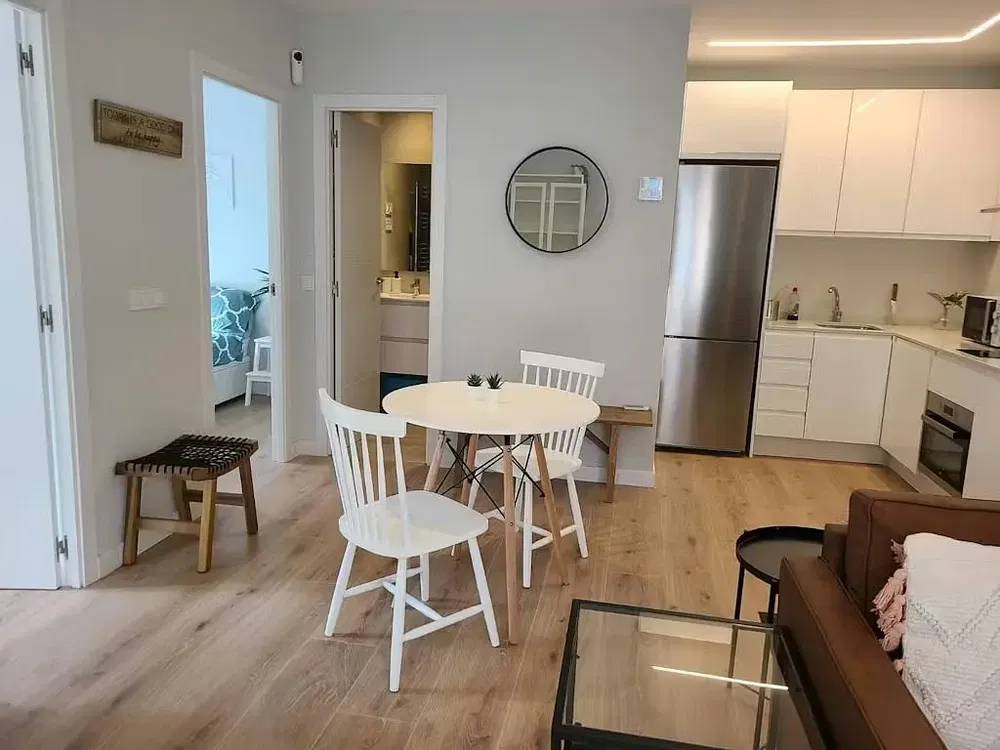 Kitchen; kitchen appliances, wood floor, natural light, modern style, renovated