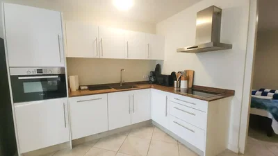 Kitchen; kitchen appliances, wood floor, natural light, modern style