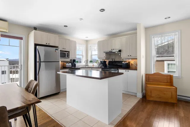 Kitchen; kitchen appliances, wood floor, natural light, modern style