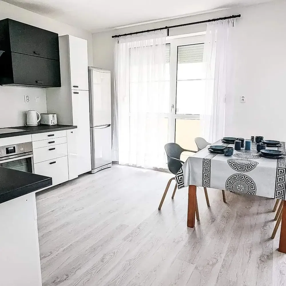 Kitchen; kitchen appliances, wood floor, natural light, modern style