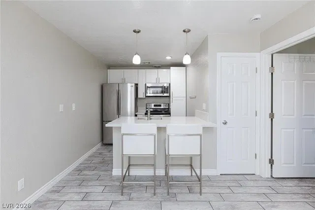 Kitchen; kitchen appliances, wood floor, natural light, modern style