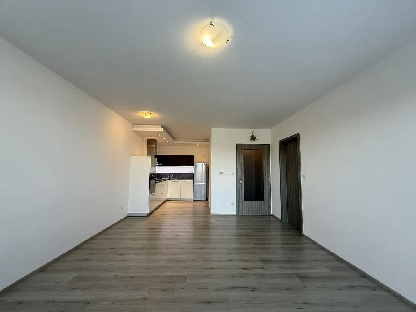 Kitchen; kitchen appliances, wood floor, natural light, modern style