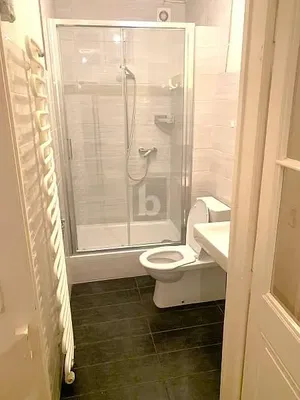 Toilet; tile floor, natural light