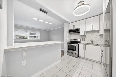 Kitchen; kitchen appliances, natural light, modern style, tile floor, renovated