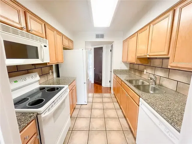 Kitchen; kitchen appliances, tile floor, natural light