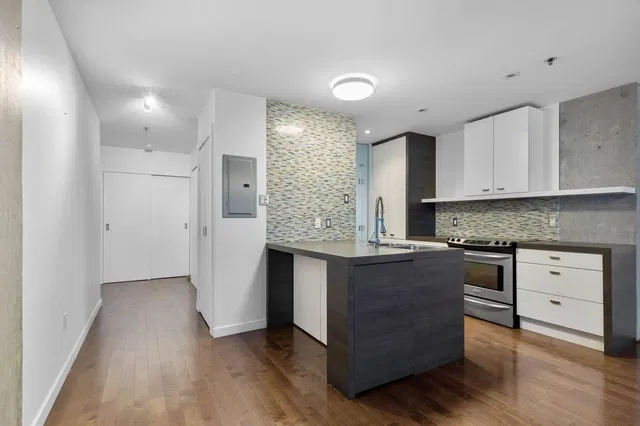 Kitchen; kitchen appliances, wood floor, renovated, natural light, modern style