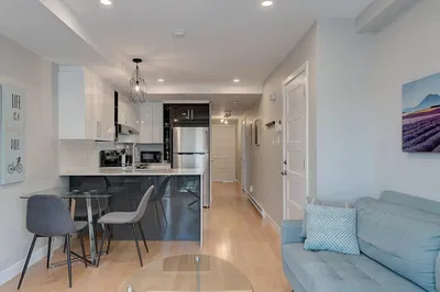 Living room; kitchen appliances, natural light, modern style, wood floor