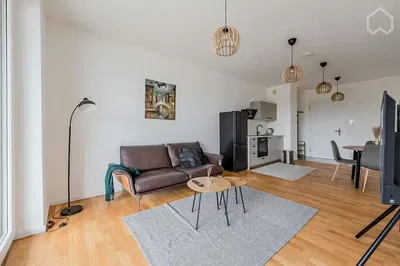 Living room; wood floor, modern style, natural light, kitchen appliances