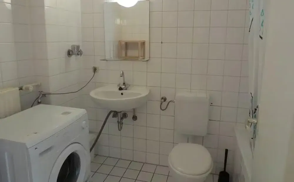 Toilet; tile floor, natural light