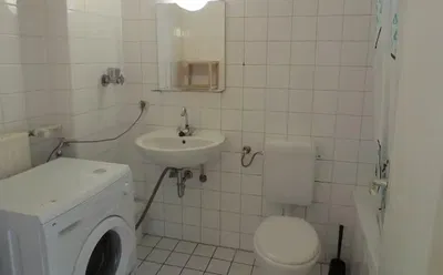 Toilet; tile floor, natural light