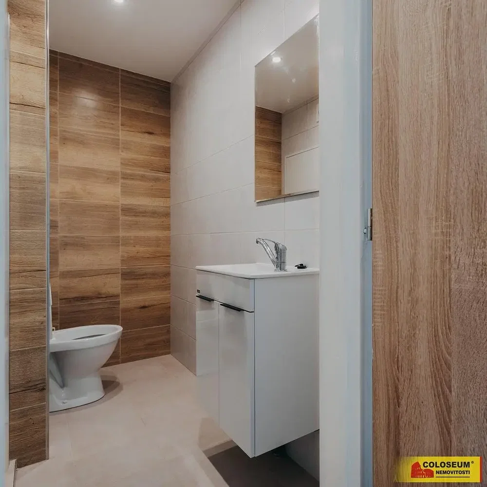 Toilet; tile floor, natural light, renovated