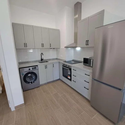 Kitchen; kitchen appliances, tile floor, renovated, natural light, modern style