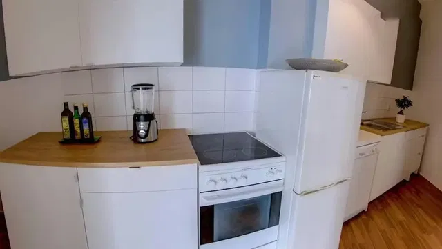 Kitchen; kitchen appliances, tile floor, wood floor, natural light, modern style