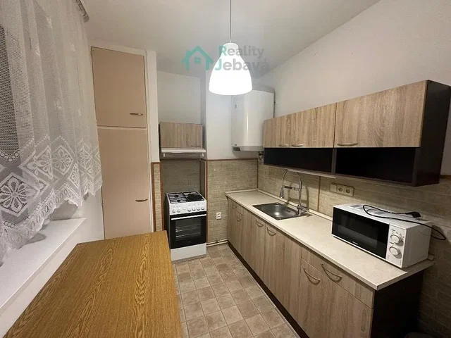 Kitchen; kitchen appliances, tile floor, natural light