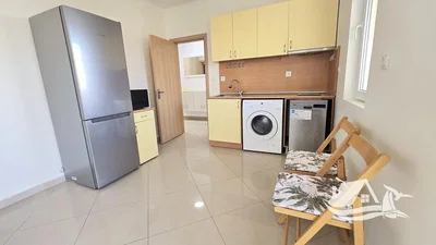 Kitchen; kitchen appliances, tile floor, natural light