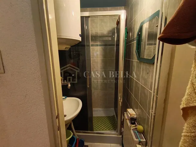 Bathroom; tile floor, water heater, natural light, needs renovation