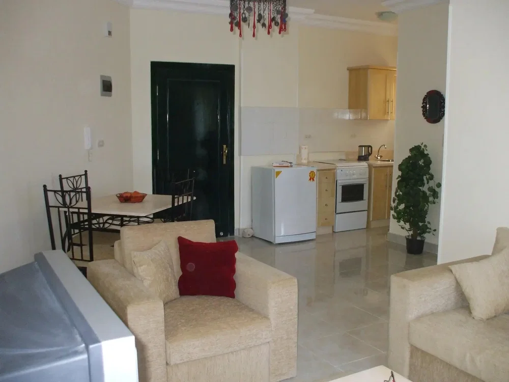 Living room; tile floor, kitchen appliances, natural light