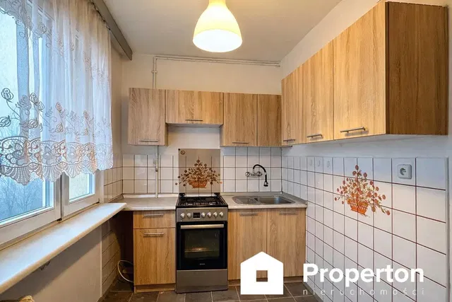 Kitchen; kitchen appliances, tile floor, natural light