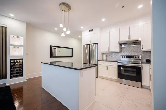 Kitchen; kitchen appliances, wood floor, tile floor, renovated, natural light, modern style