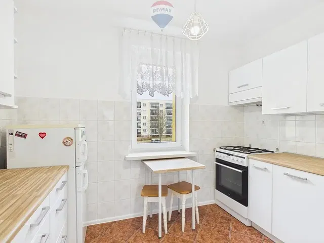 Kitchen; kitchen appliances, tile floor, natural light, modern style