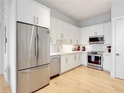 Kuchyně; kuchyňské spotřebiče, dřevěná podlaha, po rekonstrukci, přirozené světlo, moderní styl