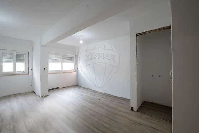 Living room; natural light, needs renovation, wood floor