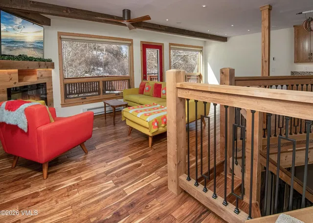 Living room; view, wood beams, wood floor, natural light, modern style, fireplace