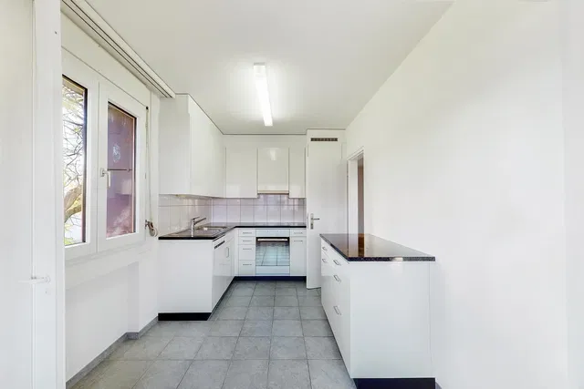 Kitchen; kitchen appliances, tile floor, natural light, renovated