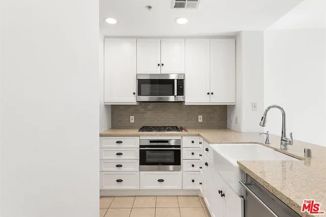 Kitchen; kitchen appliances, tile floor, renovated, natural light, modern style