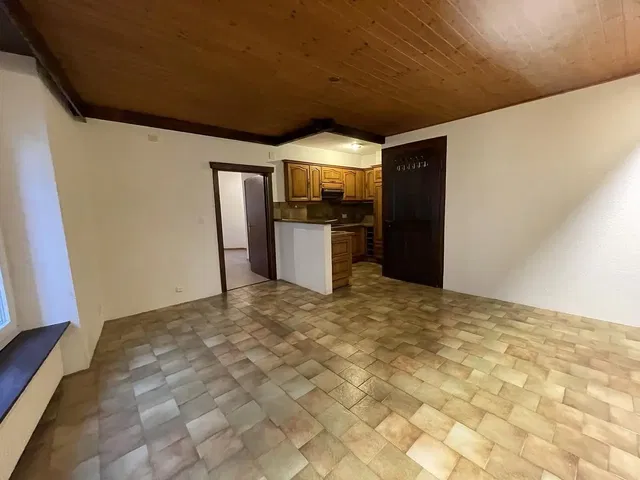 Living room; tile floor, wood beams