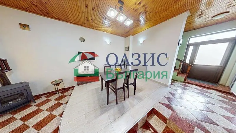 Living room; wood beams, fireplace, tile floor