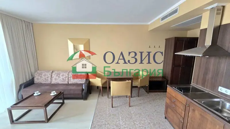 Living room; kitchen appliances, wood floor, natural light