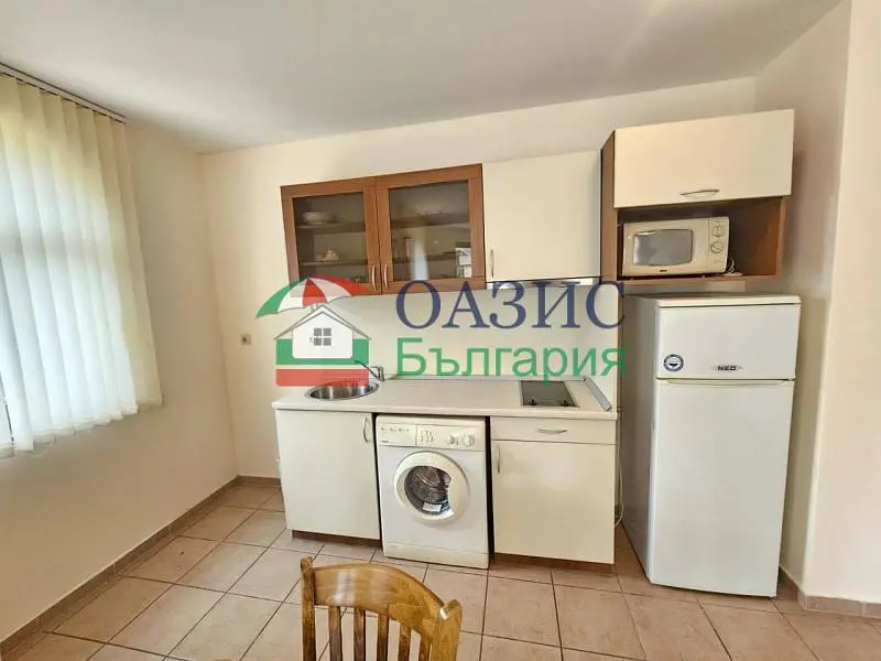 Kitchen; kitchen appliances, tile floor, natural light