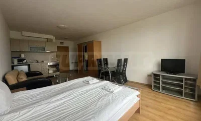 Bedroom; kitchen appliances, wood floor, natural light