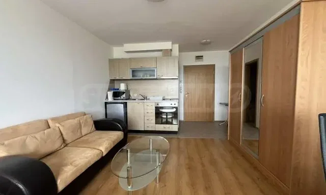 Living room; kitchen appliances, wood floor, natural light