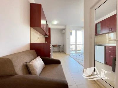 Living room; tile floor, natural light, kitchen appliances