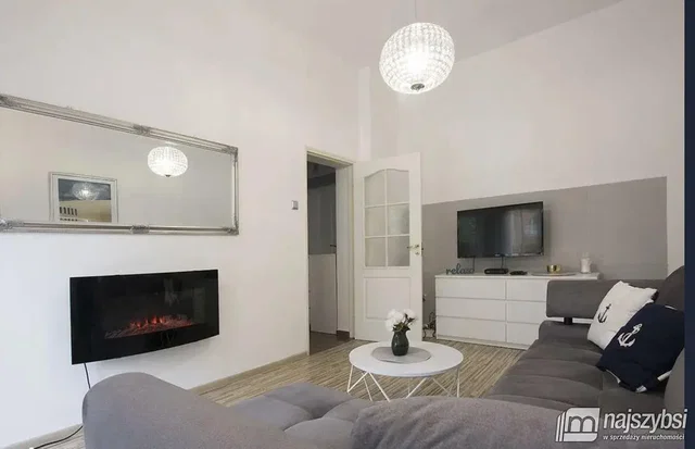 Sala de estar; chão de madeira, lareira, luz natural, estilo moderno