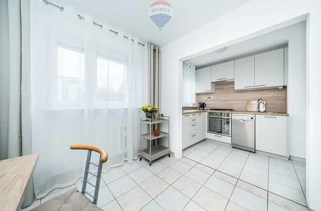 Kitchen; kitchen appliances, tile floor, natural light