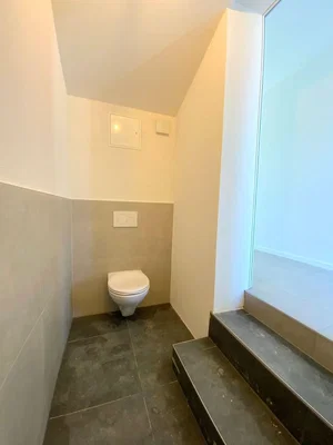Toilet; tile floor, needs renovation