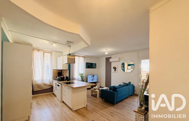 Living room; natural light, wood floor, kitchen appliances