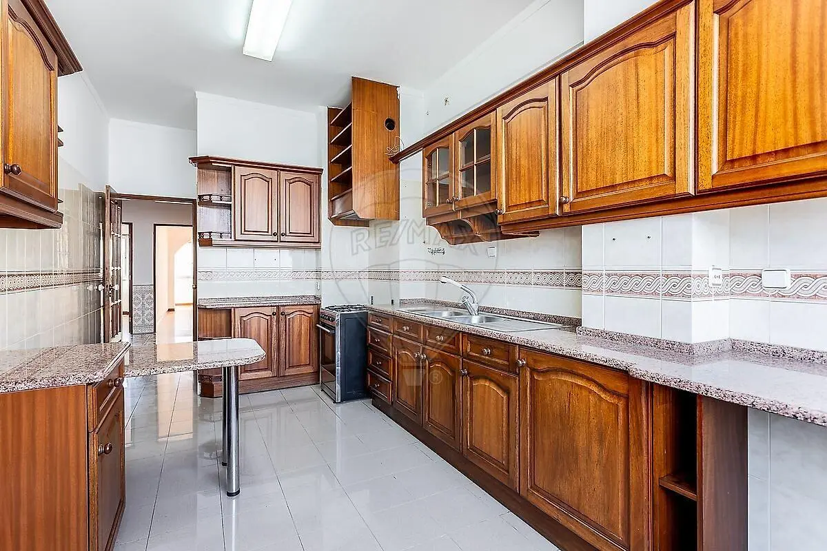 Kitchen; kitchen appliances, tile floor, natural light