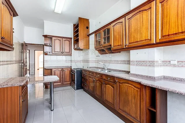 Kitchen; kitchen appliances, tile floor, natural light