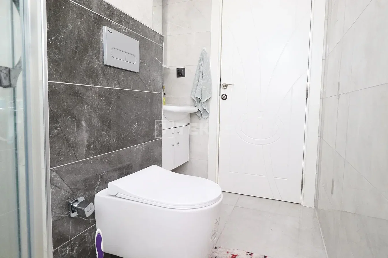 Toilet; tile floor, natural light