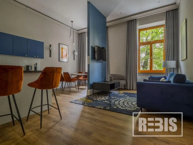 Living room; kitchen appliances, wood floor, natural light, modern style