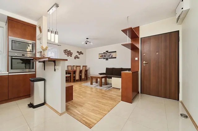 Living room; kitchen appliances, wood floor, natural light