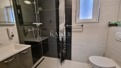Toilet; tile floor, natural light, renovated