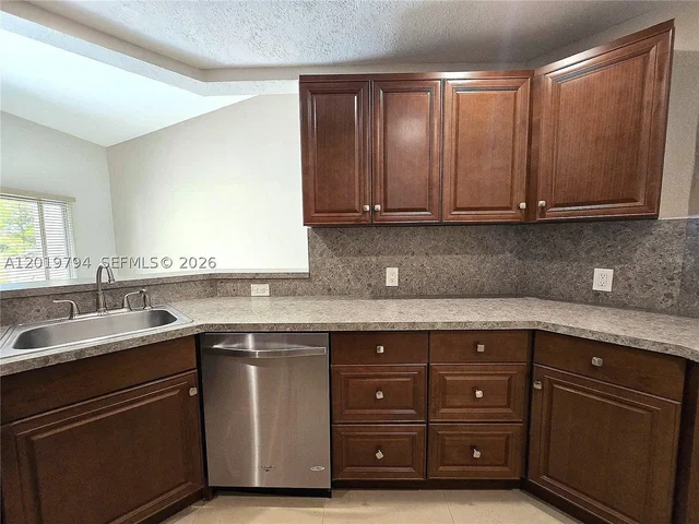 Kitchen; kitchen appliances, tile floor, natural light