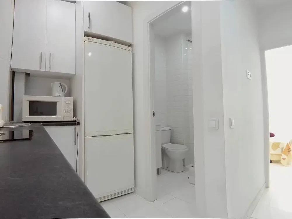 Kitchen; kitchen appliances, tile floor, natural light